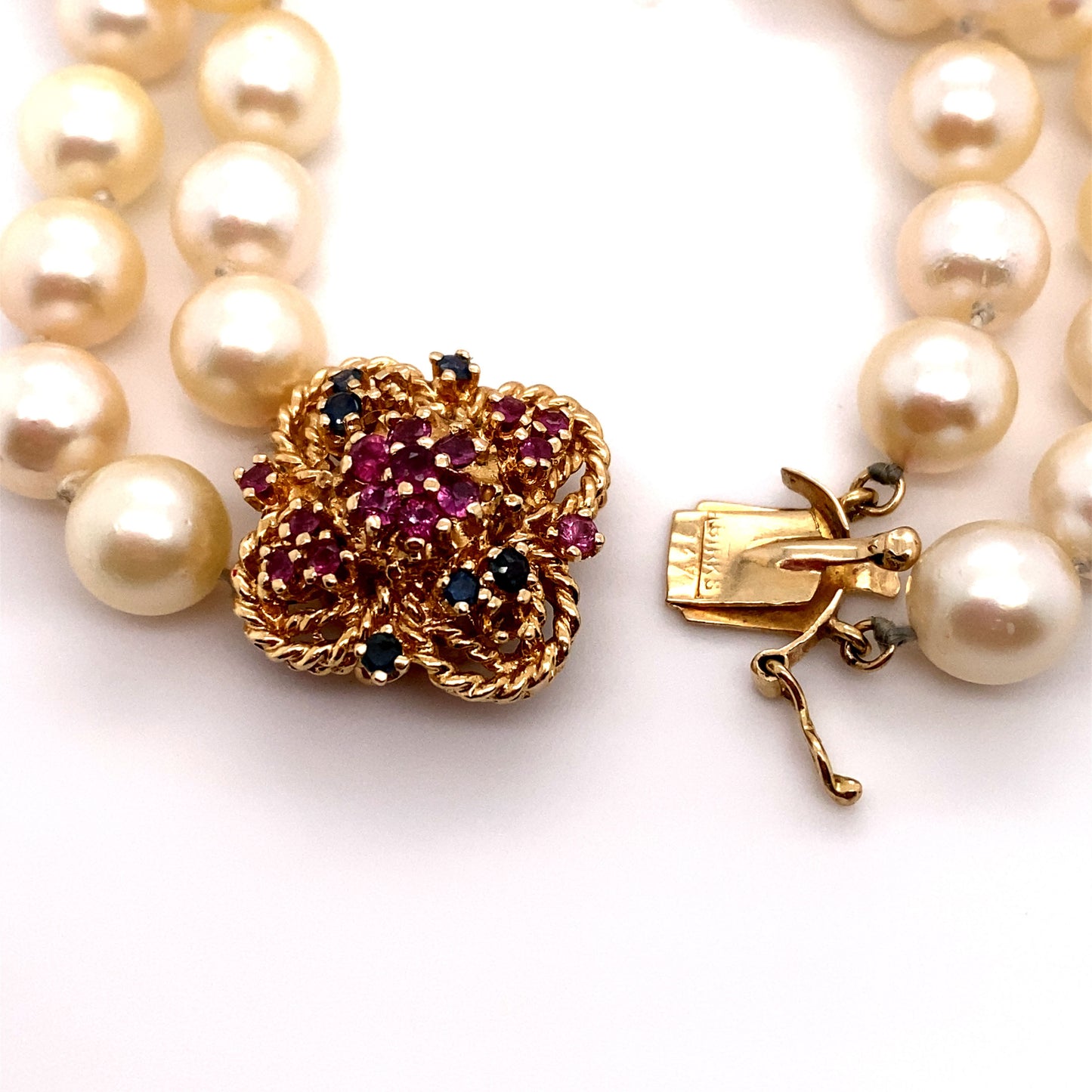 Circa 1980 Double Strand Pearl Bracelet with Ruby and Sapphire Clasp in 14 Karat Gold