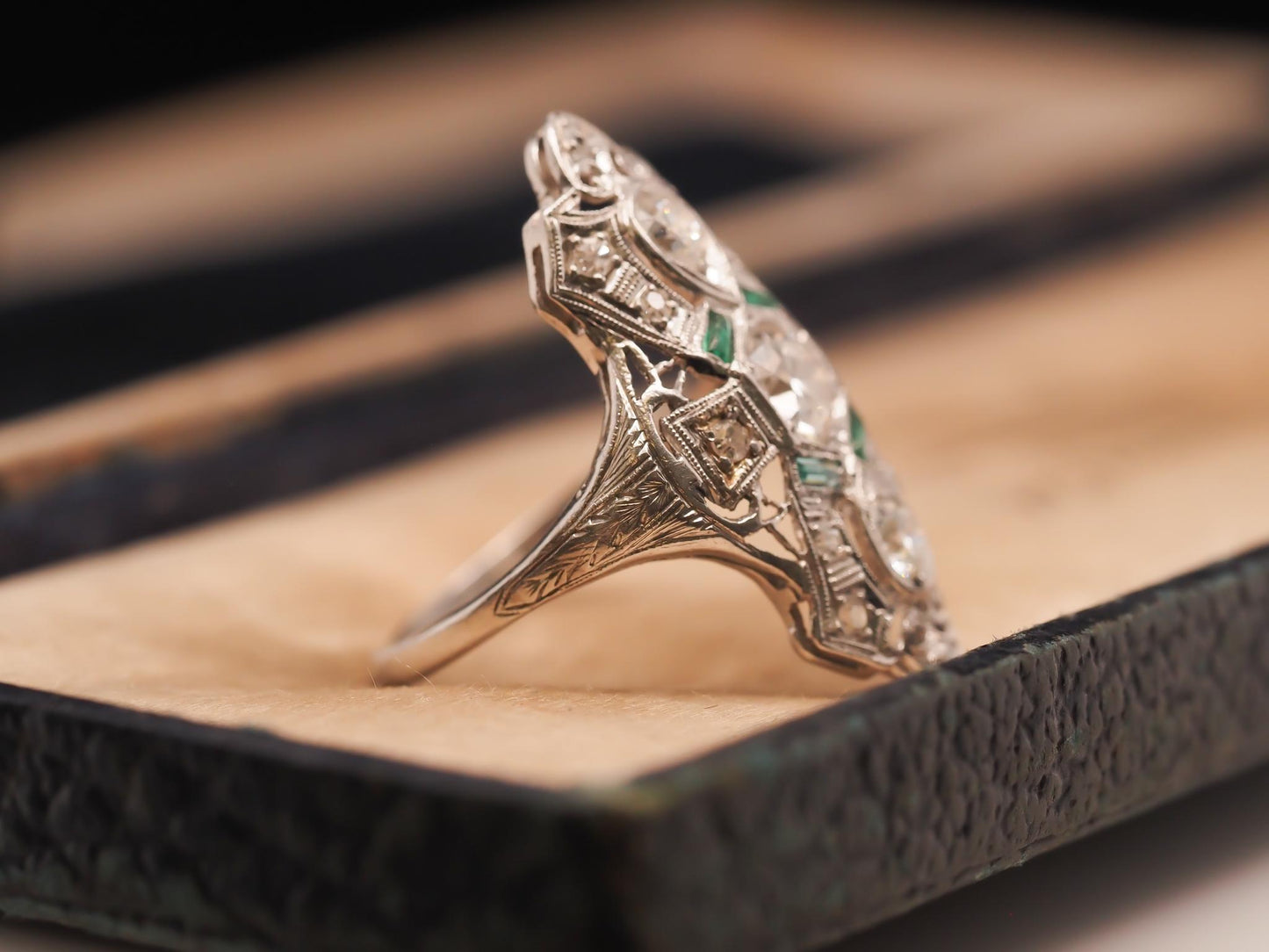 Circa 1920s Platinum Shield Ring with Old European Cut Diamond and Emeralds