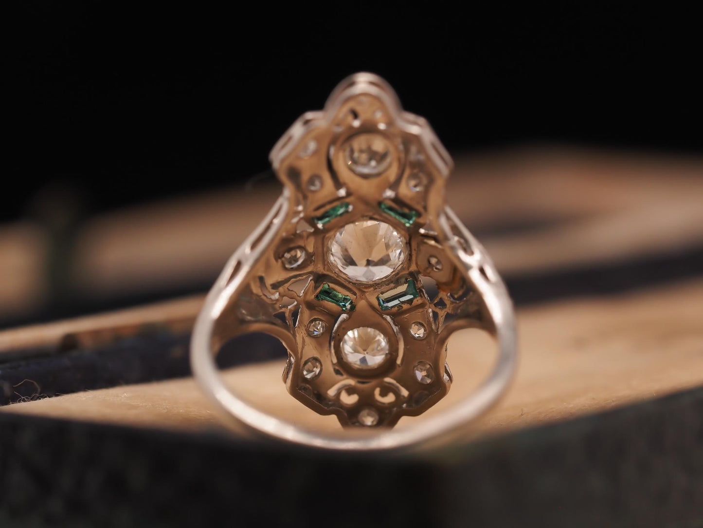 Circa 1920s Platinum Shield Ring with Old European Cut Diamond and Emeralds
