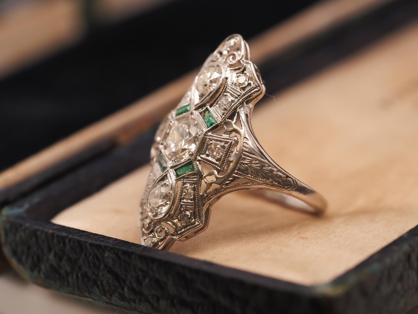 Circa 1920s Platinum Shield Ring with Old European Cut Diamond and Emeralds