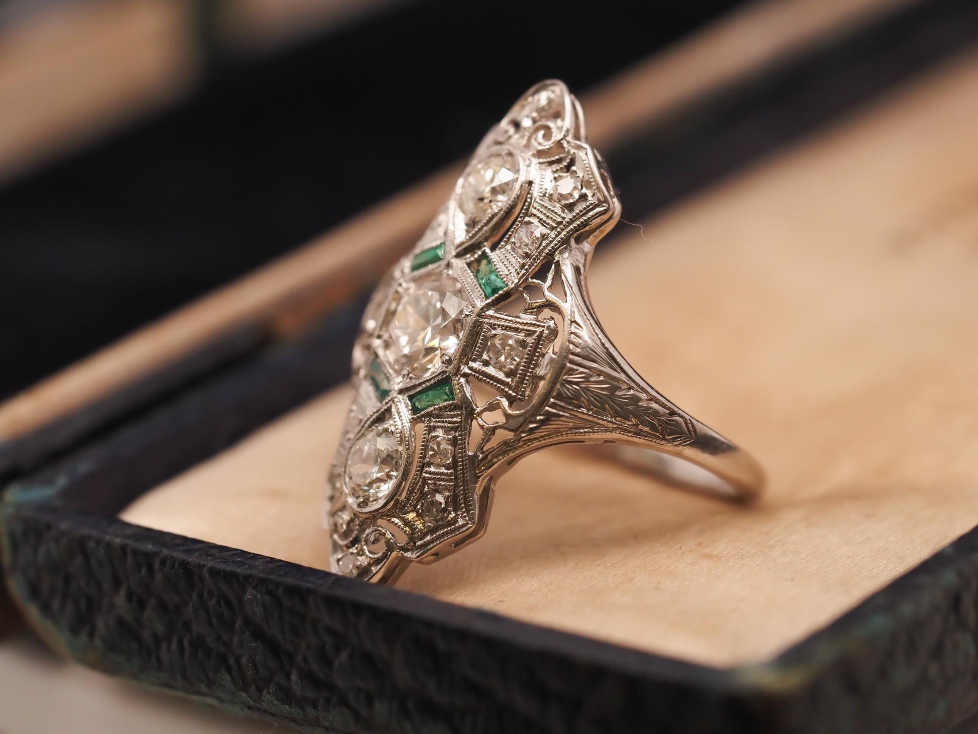 Circa 1920s Platinum Shield Ring with Old European Cut Diamond and Emeralds