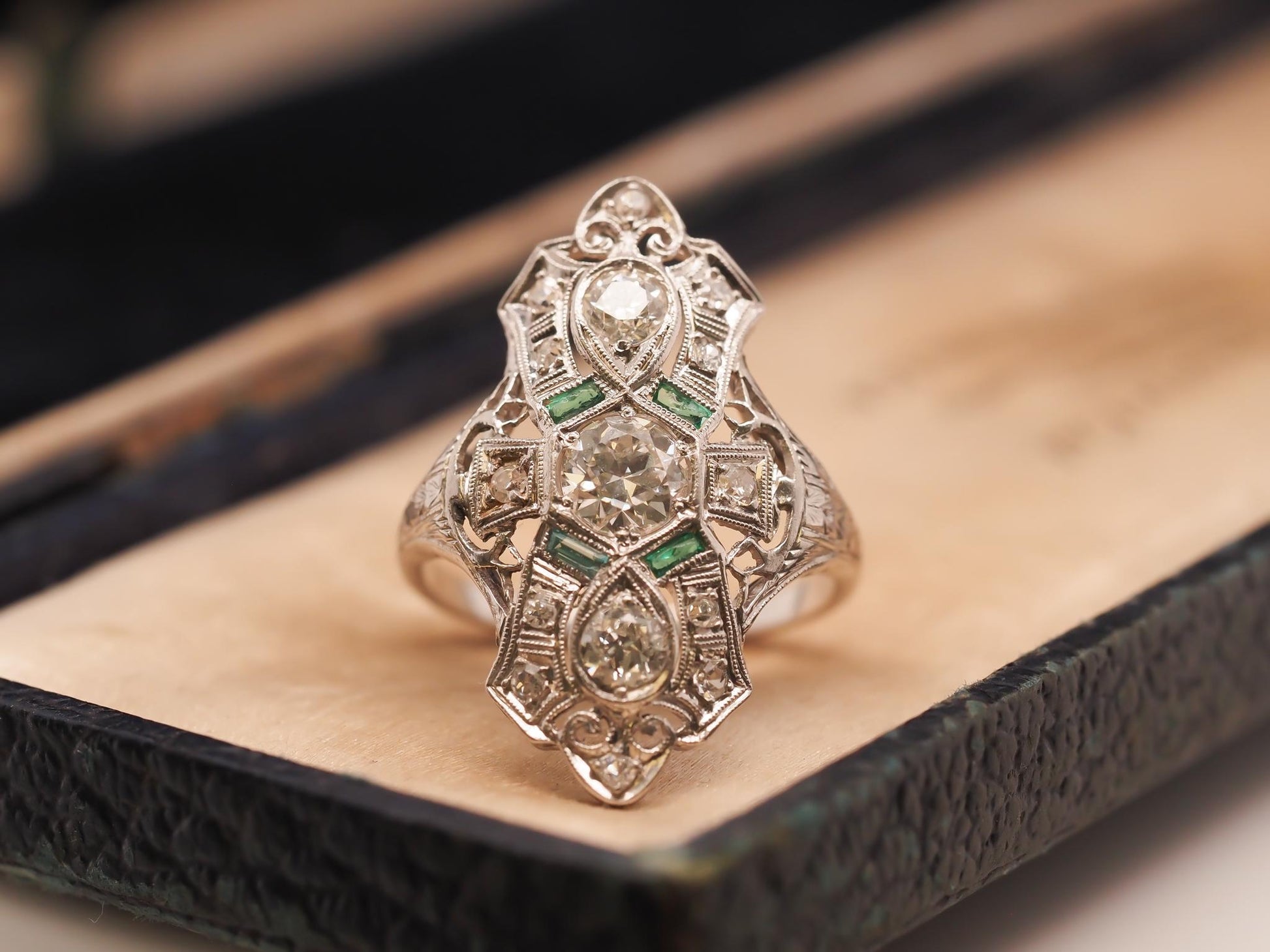 Circa 1920s Platinum Shield Ring with Old European Cut Diamond and Emeralds