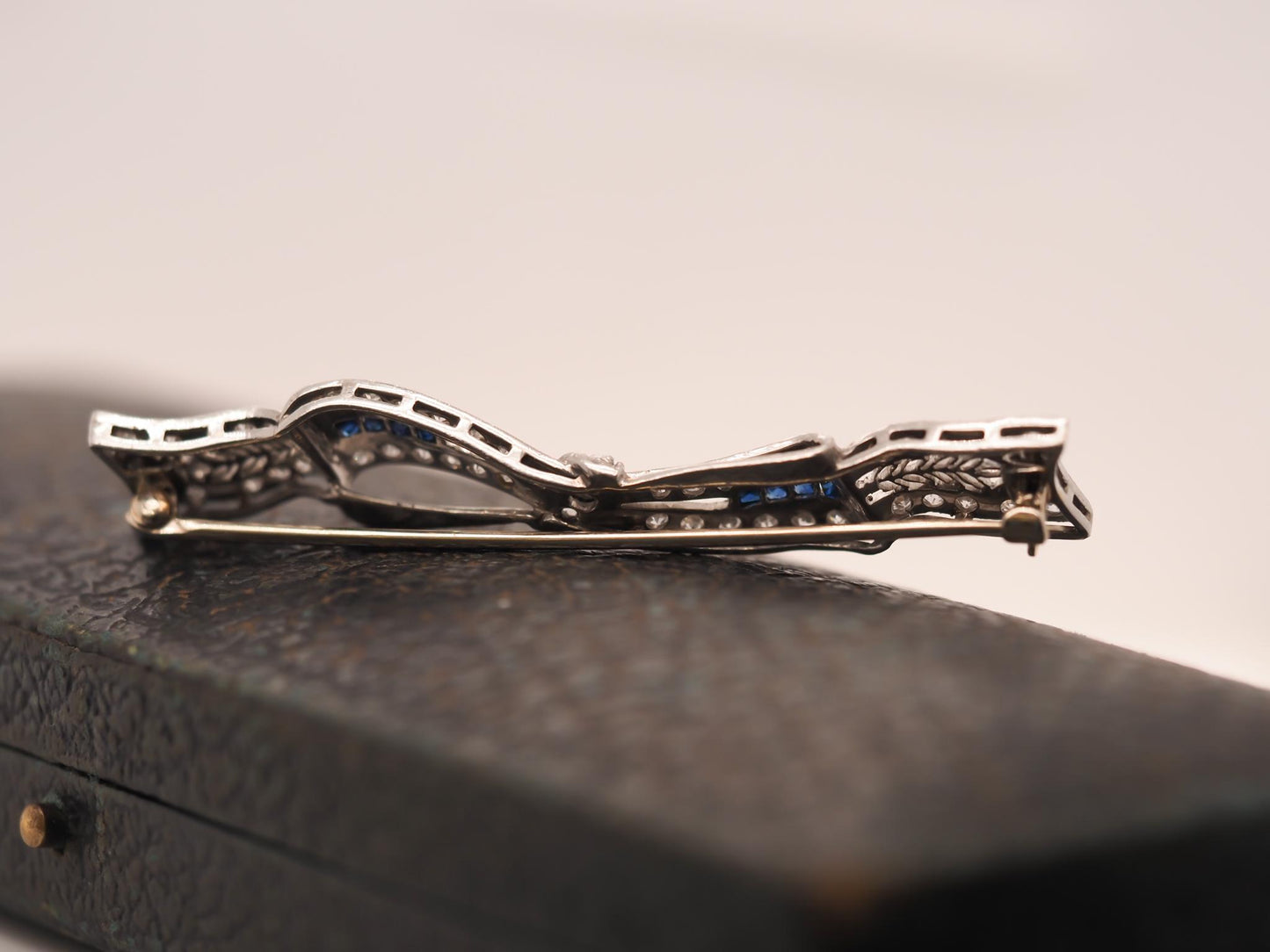 Circa 1920s Art Deco Platinum Sapphire and Diamond Ribbon Brooch