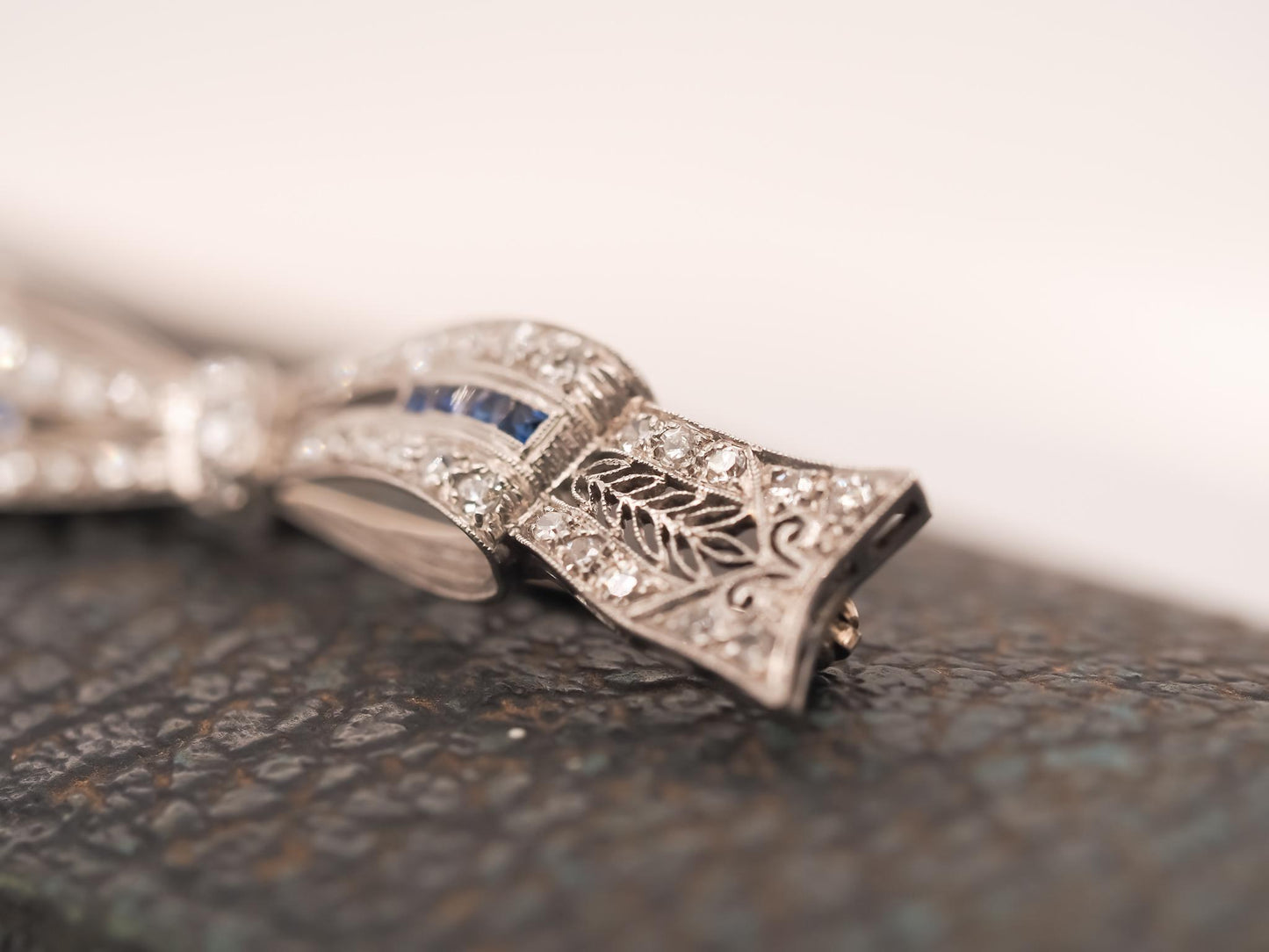Circa 1920s Art Deco Platinum Sapphire and Diamond Ribbon Brooch