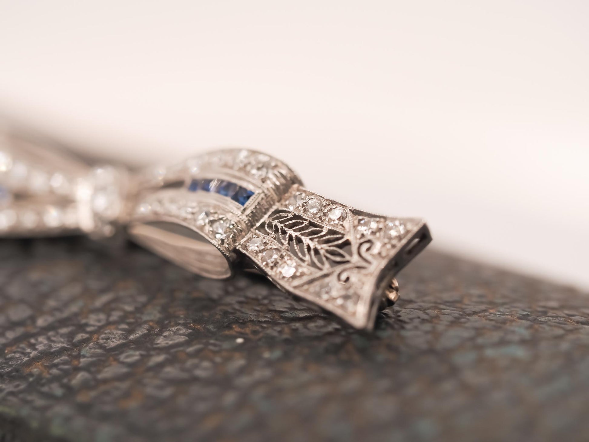 Circa 1920s Art Deco Platinum Sapphire and Diamond Ribbon Brooch