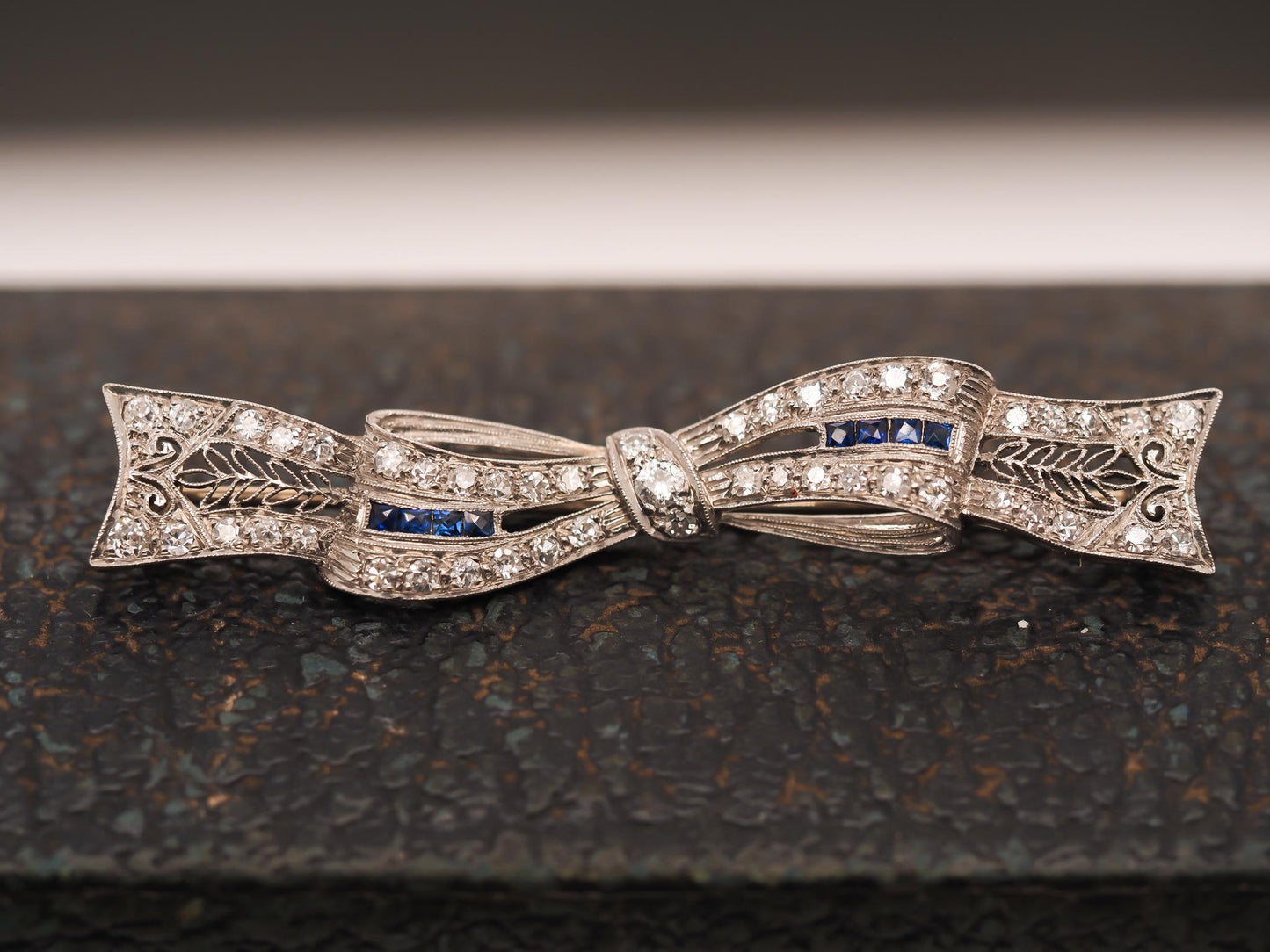 Circa 1920s Art Deco Platinum Sapphire and Diamond Ribbon Brooch