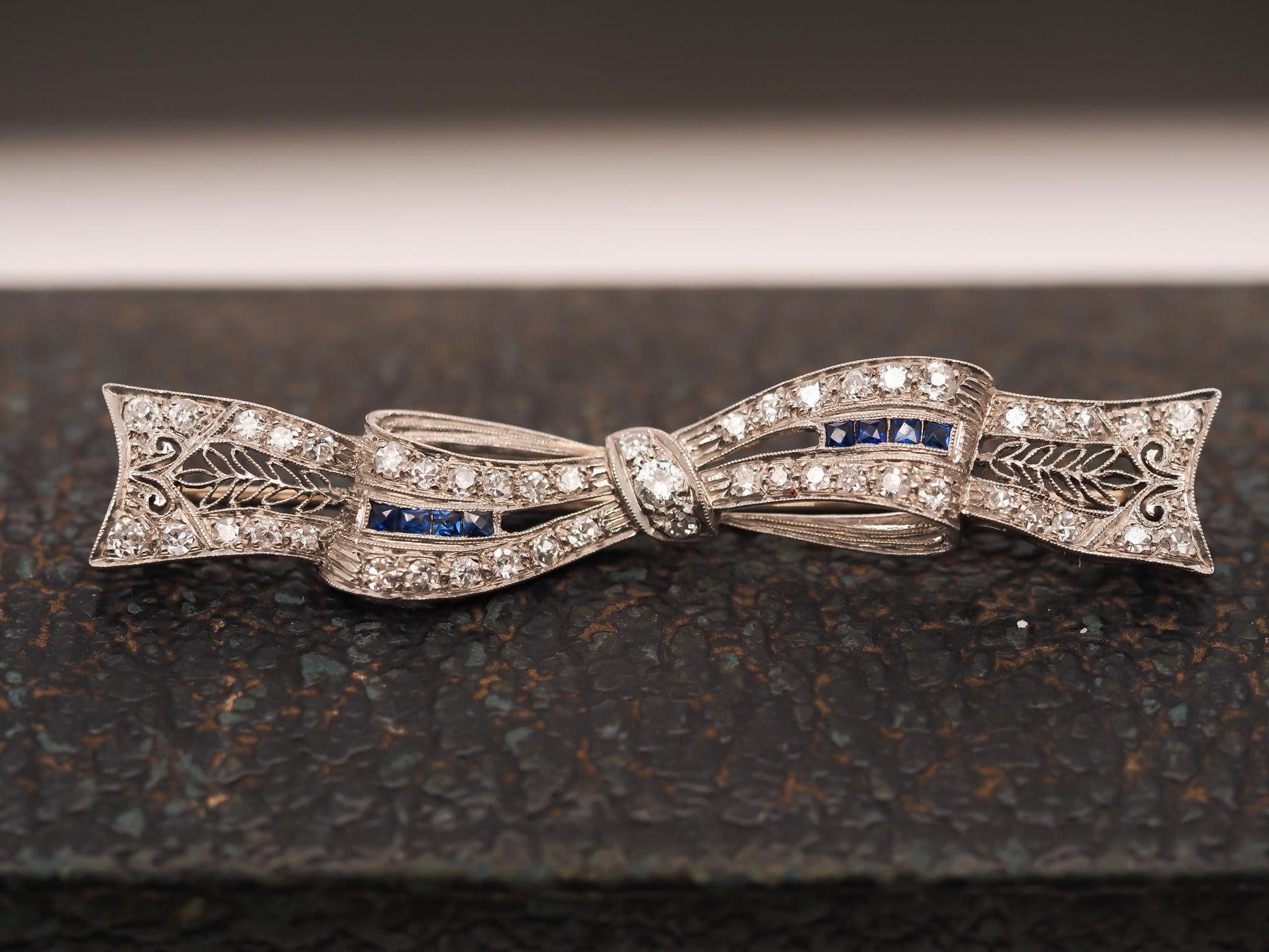 Circa 1920s Art Deco Platinum Sapphire and Diamond Ribbon Brooch
