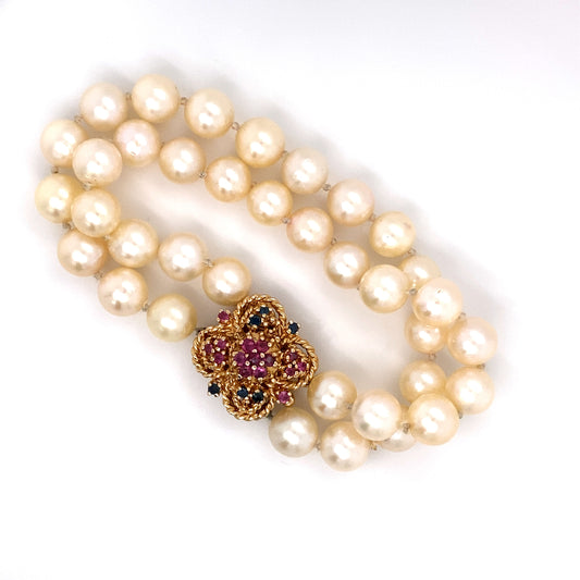 Circa 1980 Double Strand Pearl Bracelet with Ruby and Sapphire Clasp in 14 Karat Gold